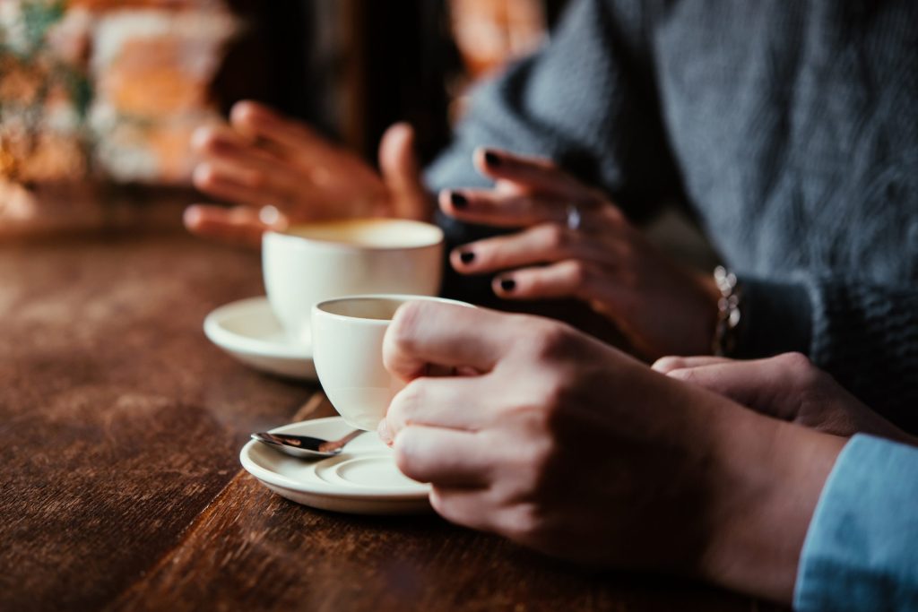 Two,Women,Discussing,Business,Projects,In,A,Cafe,While,Having