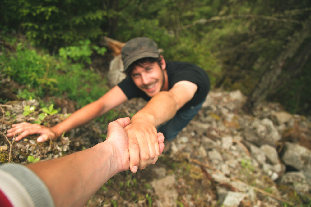 hand helping a climber raise the top