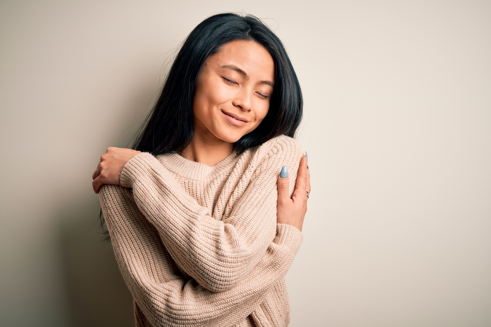 woman hugging oneself