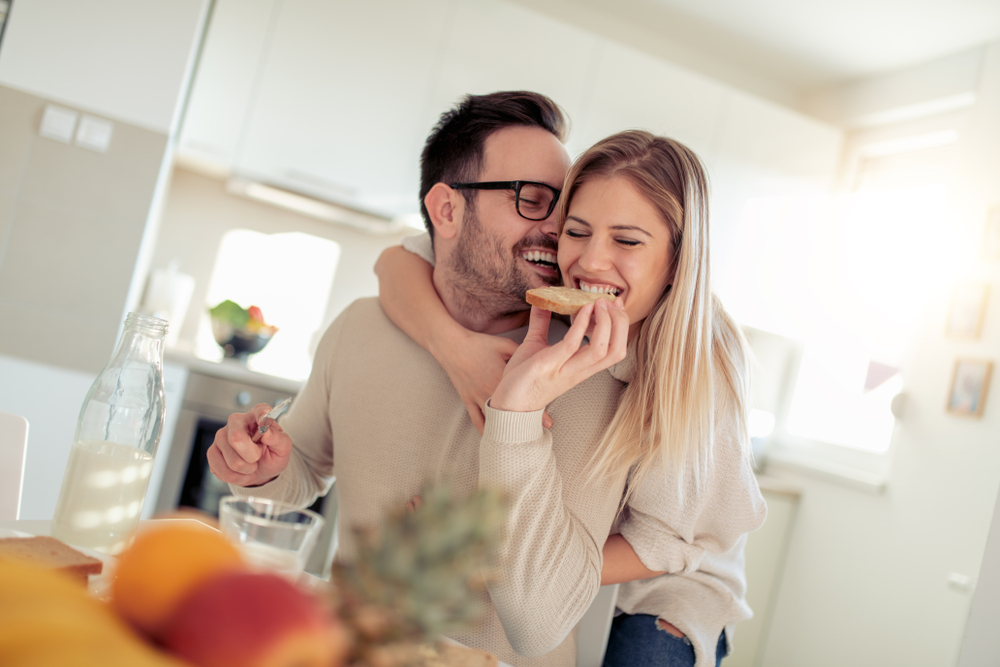 couple all smiles eating breakfast 