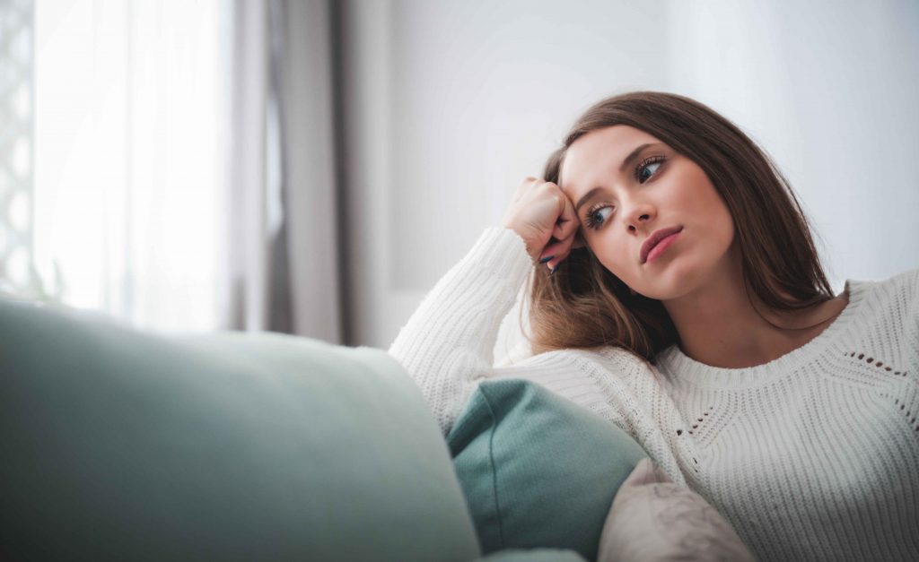 sad-woman-sitting-on-a-sofa