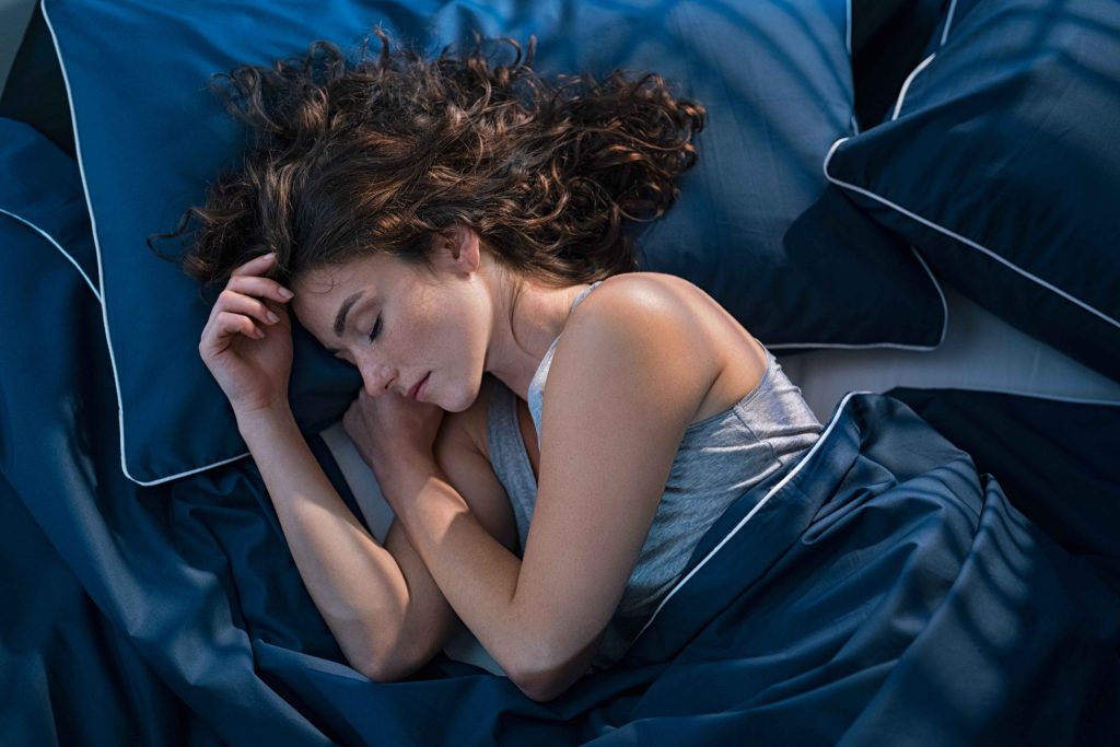 woman sleeping on a bed 