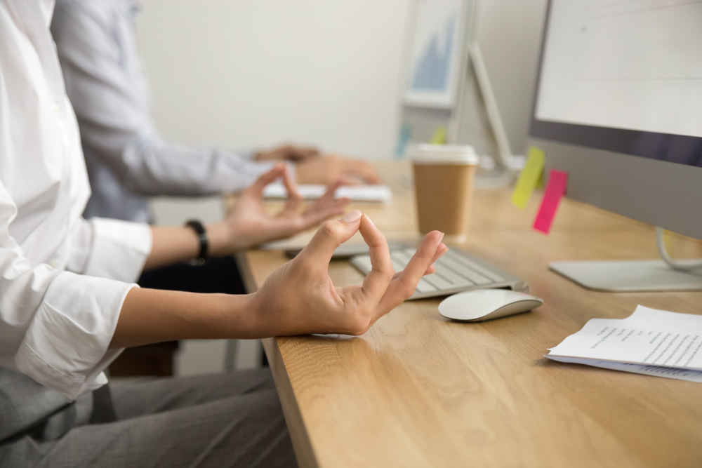 closeup of woman meditating at work