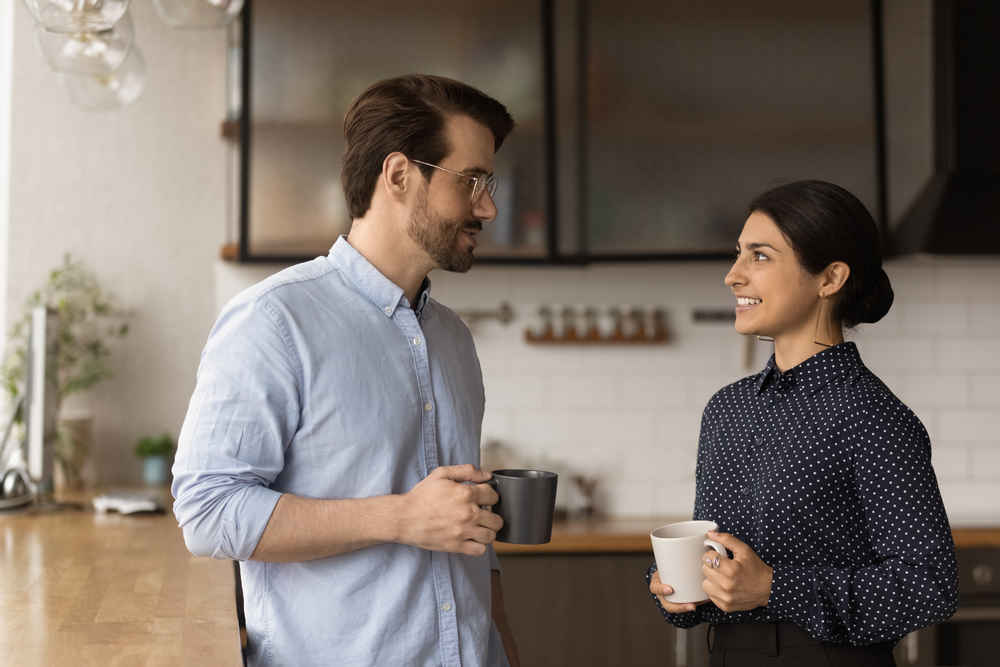 coworkers chatting while drinking coffee