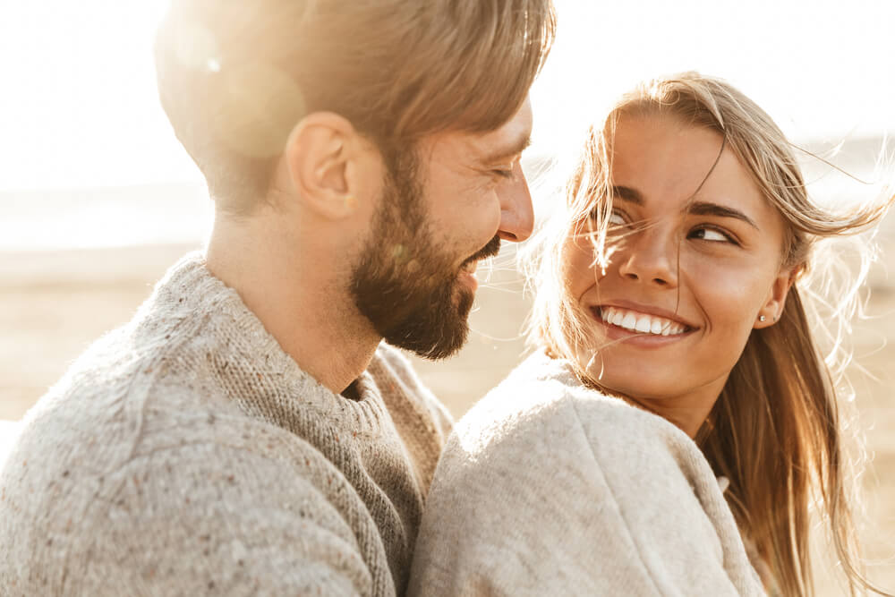 close up of smiling couple embracing