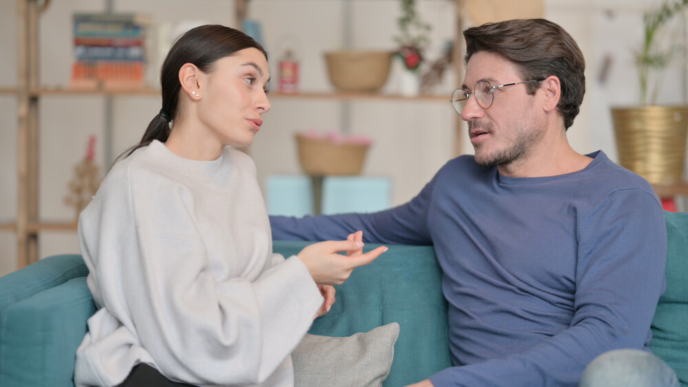 couple sitting on couch having a conversation