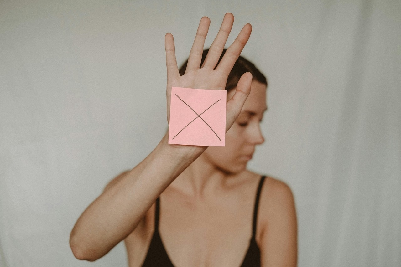 Woman Showing an X to Life.