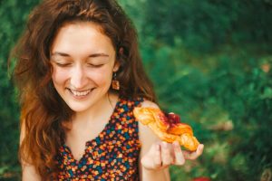 Woman Mindfully Eating a Croissant.