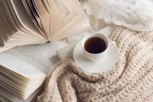 5 Self-Care Practices to Apply in Every Area of Your Life books and cup of coffee on bed